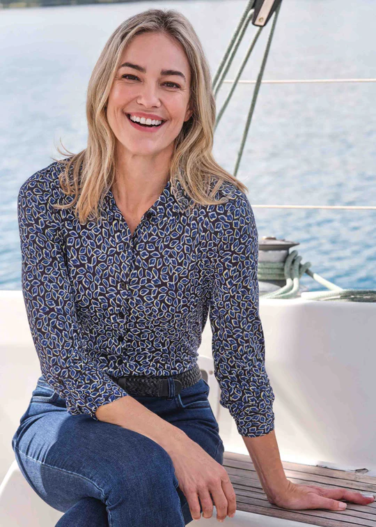 Woman wears dark blue patterned shirt with velcro fastening